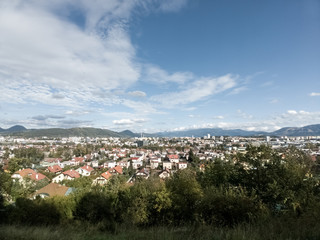 Sunrise and sunset, beautiful clouds over the meadow, hills and buildings in the town. Slovakia