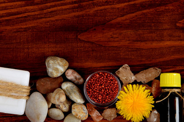 soap, small bath balls, essential oil with yellow dandelion flower with free space for text