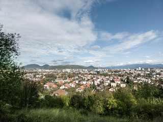 Sunrise and sunset, beautiful clouds over the meadow, hills and buildings in the town. Slovakia