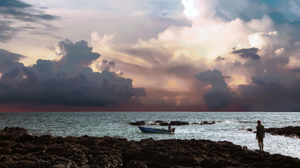 Couché de soleil dans un ciel gris au dessus de la mer