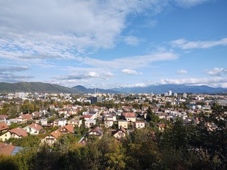 Sunrise and sunset, beautiful clouds over the meadow, hills and buildings in the town. Slovakia