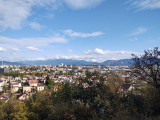 Obraz premium Sunrise and sunset, beautiful clouds over the meadow, hills and buildings in the town. Slovakia