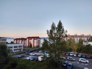 Sunrise and sunset, beautiful clouds over the meadow, hills and buildings in the town. Slovakia