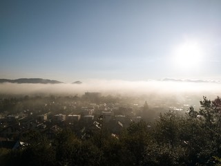 Obraz premium Sunrise and sunset, beautiful clouds over the meadow, hills and buildings in the town. Slovakia