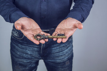 man holds a big key in the palms