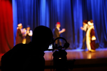 cameraman recording theater scene and actors