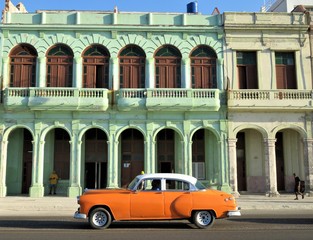 Traditional Cuban antique car driving through Havana