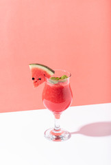 Fresh water melon juice and watermelon slice on color background. summer drink.