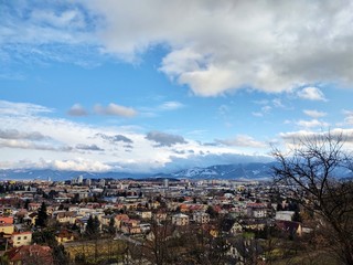 Sunrise and sunset, beautiful clouds over the meadow, hills and buildings in the town. Slovakia