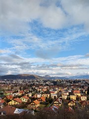 Sunrise and sunset, beautiful clouds over the meadow, hills and buildings in the town. Slovakia