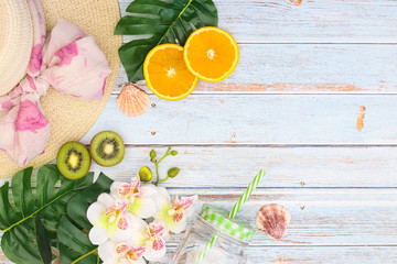 Summer vacation concept with leaves and sliced fruit 