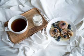 Cheesecakes with condensed milk and berries for Breakfast. Cup of tea