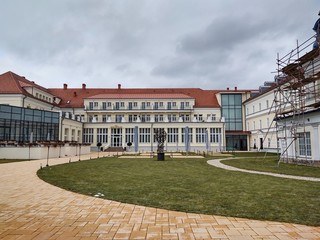 Obraz premium Sunrise and sunset, beautiful clouds over the meadow, hills and buildings in the town. Slovakia