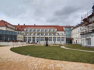 Obraz premium Sunrise and sunset, beautiful clouds over the meadow, hills and buildings in the town. Slovakia