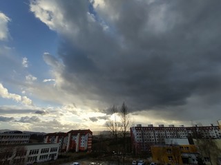Sunrise and sunset, beautiful clouds over the meadow, hills and buildings in the town. Slovakia