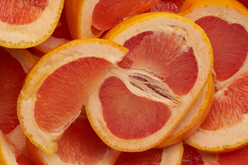 Grapefruit web banner background. Pile of fresh cut grapefruits. Fruits summer bright concept