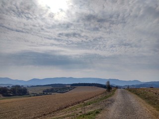 Sunrise and sunset, beautiful clouds over the meadow, hills and buildings in the town. Slovakia