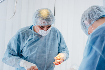 Operation in a modern operating room close-up, emergency rescue and resuscitation of the patient. Medicine and surgery