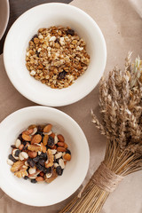 
Oatmeal, granola in plates and dried flowers