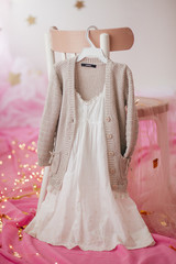 Stock Photo - Child dress on hanger on pink background