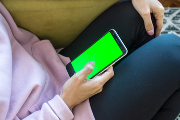 woman holding a cell phone with her hands