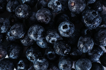 .Pattern with blueberries on a dark background. View from above. Vegetarian healthy food. Healthy breakfast. Natural background Fresh fruits.