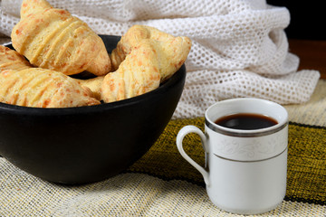 Traditional Brazilian Biscuit with Fresh Cheesebaked cheese biscuit, with cup of coffee, on the table.