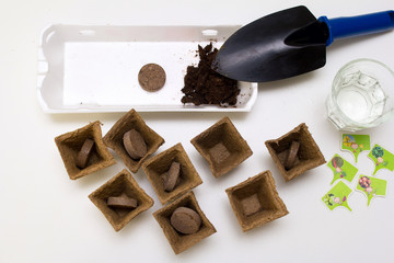 Garden tools: shovel, peat pots. Seeds and home gardening. Growing food at home. mock up of peat...