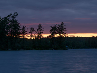 Fototapeta na wymiar A long exposure of a sunset over Eagle Lake, Ontario, Canada