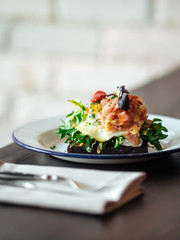 Breakfast rye toast with poached egg and salmon