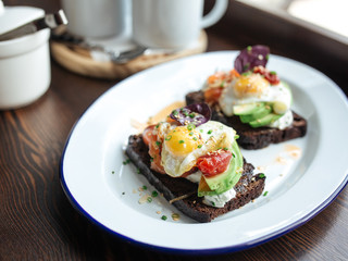 Breakfast rye toast with avocado poched egg salmon