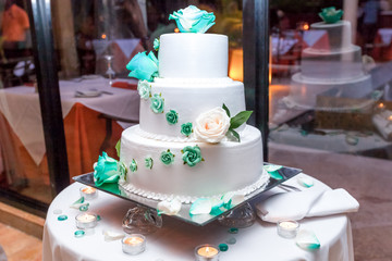 Tropical wedding cake for bride and groom to cut during destination wedding marriage outdoor ceremony on the sandy beach in Dominican republic 