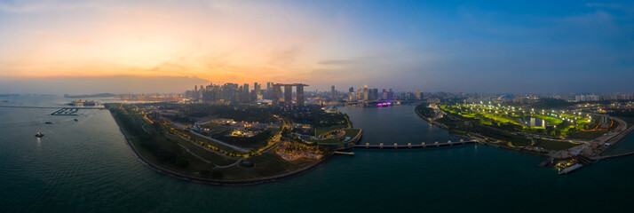 Drone view of Singapore Gardens by the Bay botanical gardens and Marina bay sands at twilight.