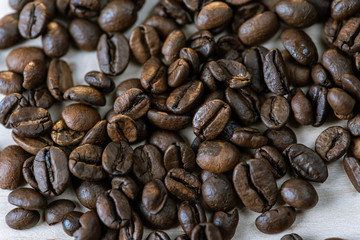 coffee beans isolated on a white background, scattered, close-up