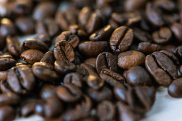 coffee beans isolated on a white background, scattered, close-up