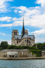 Fototapeta na wymiar Notre Dame Cathedral on a background of blue sky with clouds.