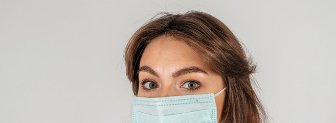 Masked woman face with sore eyes with copy space web banner: pandemic concept and flu epidemic