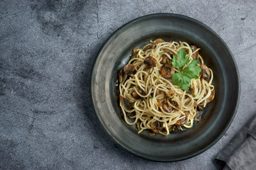 spaghetti with mushrooms on a dark background