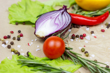 Summer vegetables (onion, garlic, tomato, pepper, rosemary and lemon) and champignon mushroom on table background.