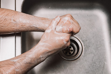 Washing hands rubbing with soap man for winter flu virus prevention