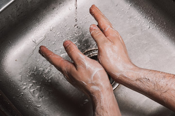 Fototapeta premium Washing hands rubbing with soap man for winter flu virus prevention