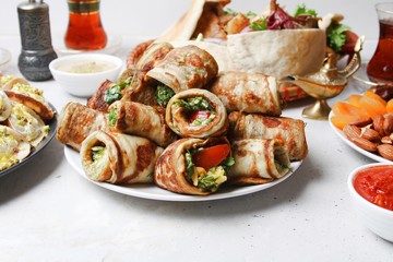 Traditional Ramadan Food. Eggplant Rolls With Herbs And Tomatoes With Arabic Meals And Sauces On Grey Background. Side View.