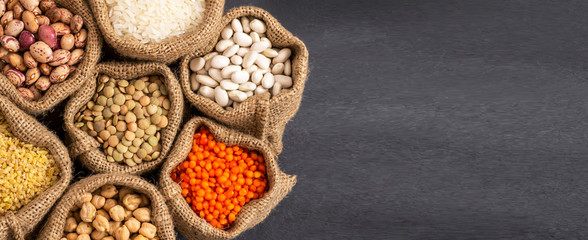 Different type of raw dry legumes composition. White beans, lentils, bulgur, chickpeas, kidney beans, corns, rice,  Mix organic legume concept