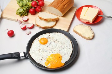 Omelet In Skillet Pan With Sliced Bread, Butter And Fresh Radish On White Backgroud. 