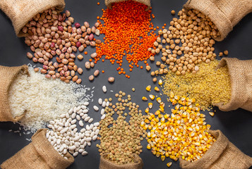 Different type of raw dry legumes composition. White beans, lentils, bulgur, chickpeas, kidney...