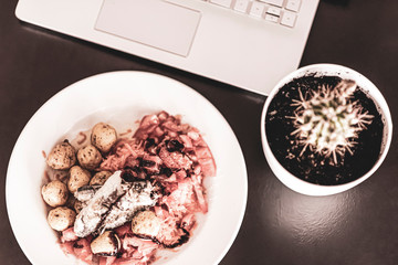 Lunch in a laptop workspace. Sea Salad Dish.