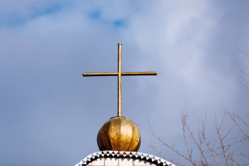 Orthodox church cross on a background of blue sky with clouds. Easter. Christmas. Place for text. Background image. Religion. selective focus