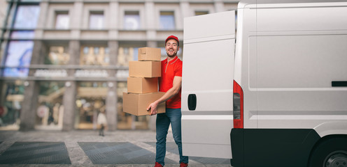 Red courier outside carries parcels with a withe van for deliveries of shipments.