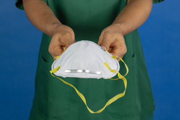 medical staff offering surgical mask for covid-19 situation