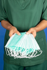 medical staff offering surgical mask for covid-19 situation